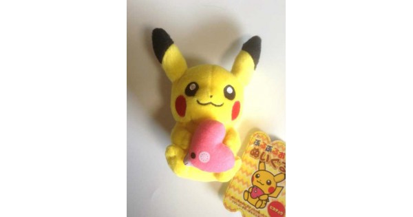 pikachu holding a heart plush